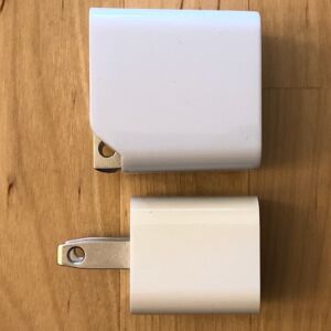 Top: AUKEY PA-Y19 Minima 27W. Bottom: Apple 5W USB Power Adapter. Top: AUKEY PA-Y19 Minima 27W. Bottom: Apple 5W USB Power Adapter.